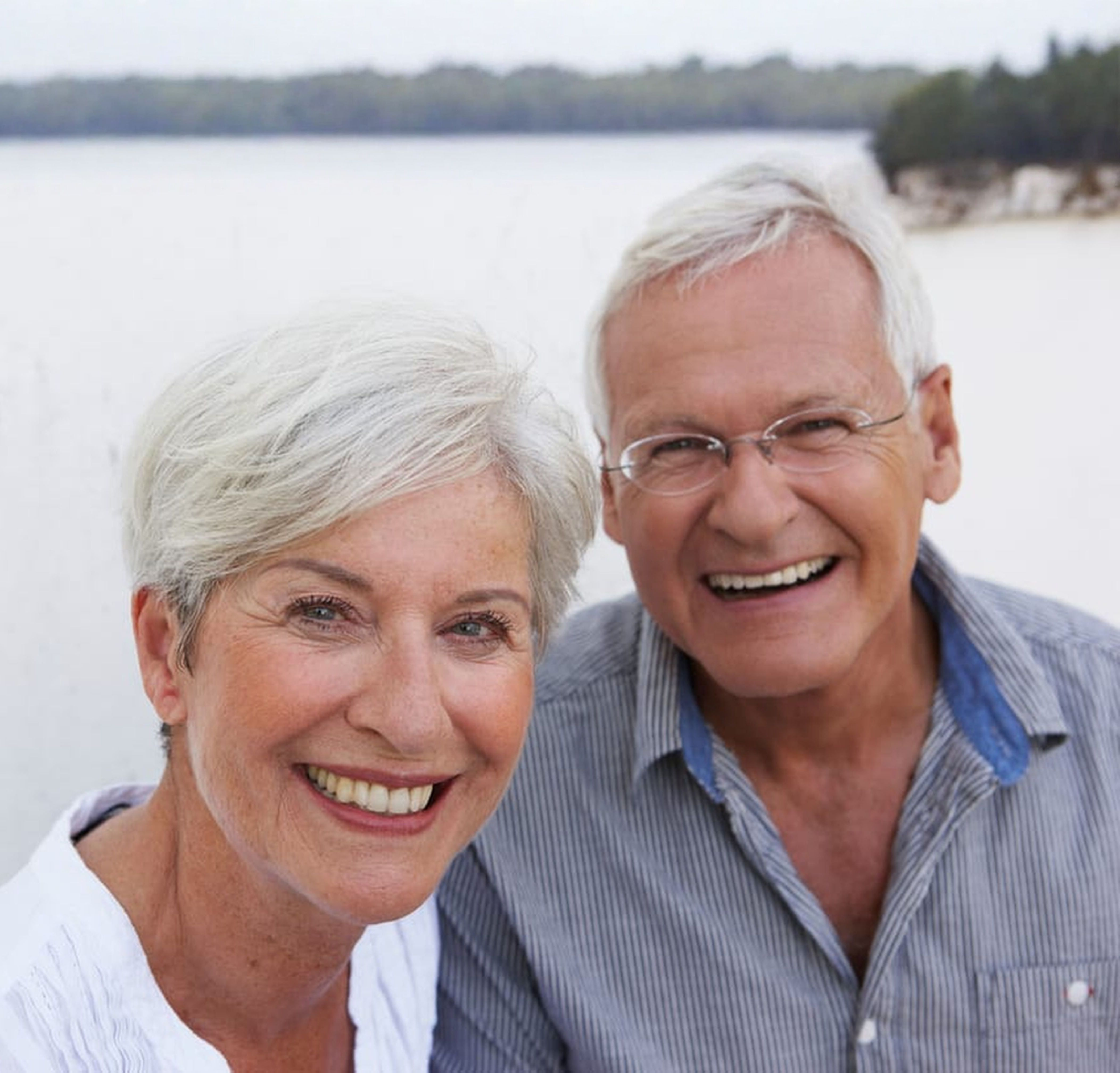 Happy senior couple with restored smiles at The Denture Professor, San Antonio TX